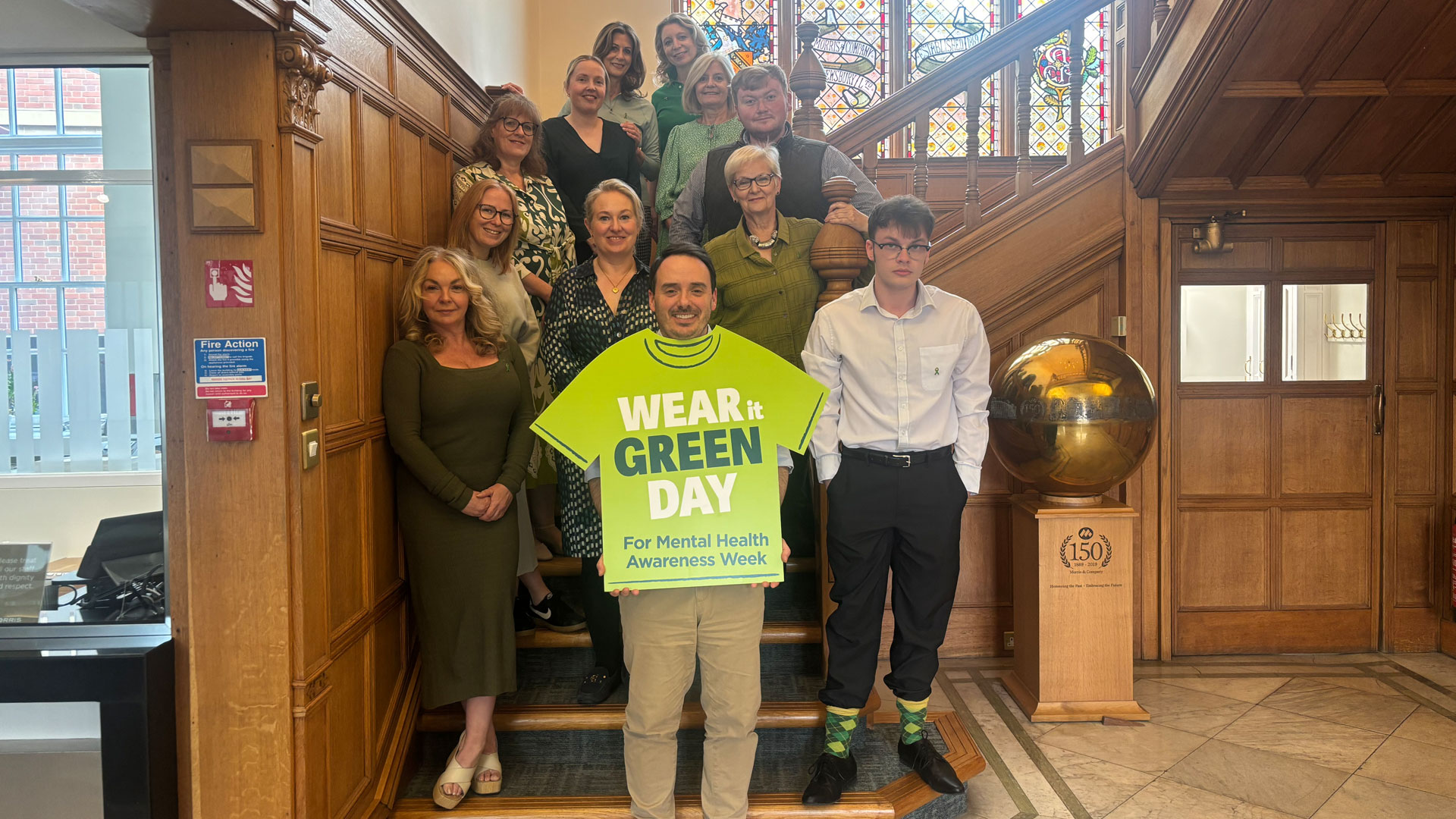 The team at Morris & Company wearing green for Mental Health Awareness Week